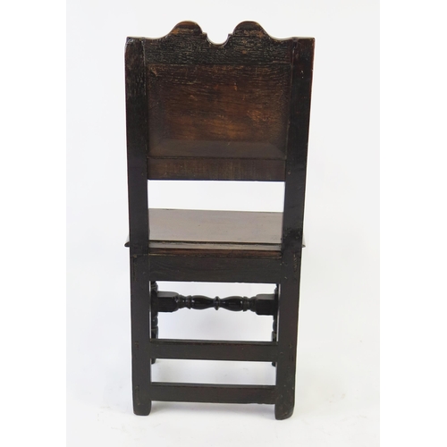 1582 - A late 18th century oak hall chair, with double arched top rail, panelled back and solid seat on tur... 