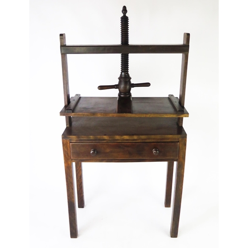 1584 - A 19th century mahogany clothes press, the rectangular press on helical screw and frame, the base co... 