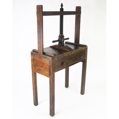 1584 - A 19th century mahogany clothes press, the rectangular press on helical screw and frame, the base co... 