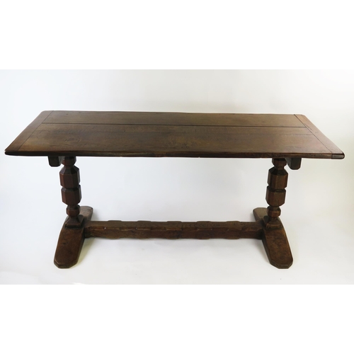 1584A - An oak refectory style table, the rectangular top raised on knopped column trestle end supports with... 