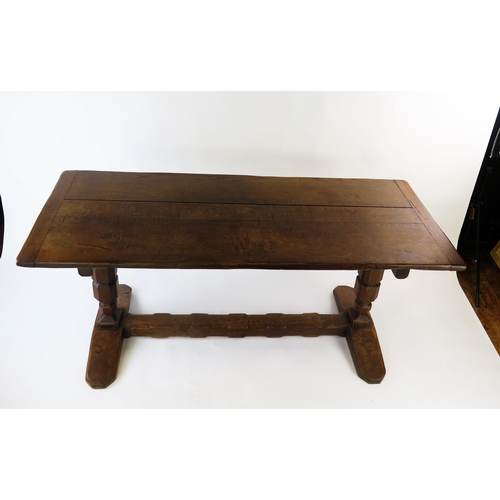 1584A - An oak refectory style table, the rectangular top raised on knopped column trestle end supports with... 