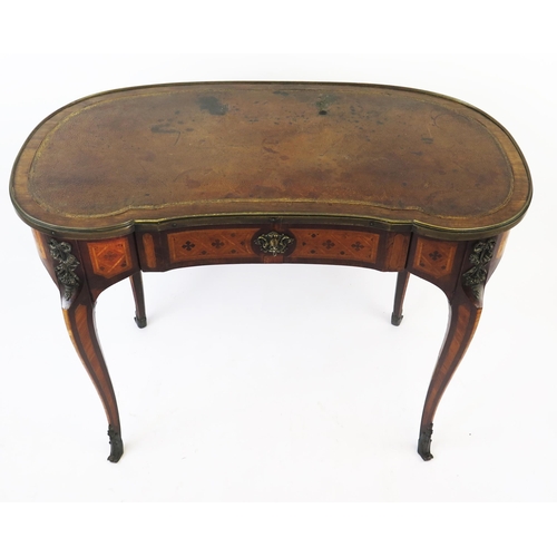 1586 - A French kingwood, rosewood an inlaid writing table of kidney-shaped outline, with tooled leather wr... 