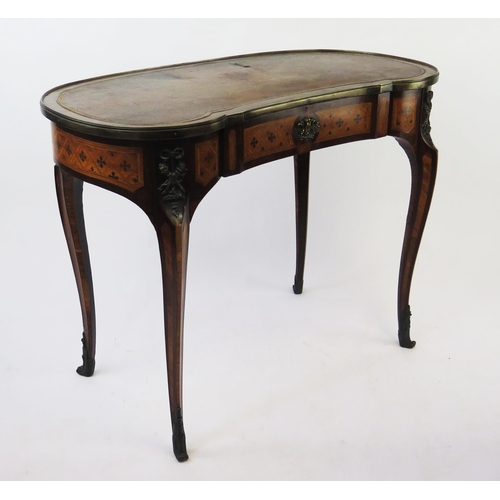 1586 - A French kingwood, rosewood an inlaid writing table of kidney-shaped outline, with tooled leather wr... 