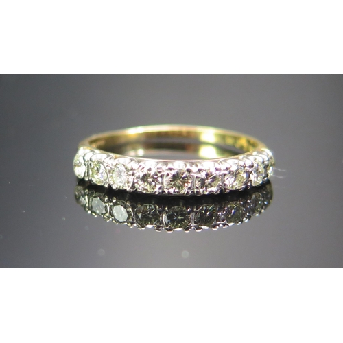 159 - An 18ct Gold and Diamond Nine Stone Half Eternity Ring, 2.7mm brilliant round cuts, size R.5, stampe... 