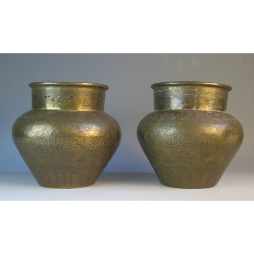 1596 - A pair of Indo-Persian brass coal  jardinières of ovoid form, with panelled and script decoration, 1... 