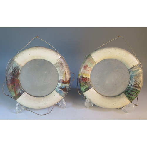 1601 - A pair of circular wall mirrors in the form of life rings, with painted decoration, 22cm diameter, (... 