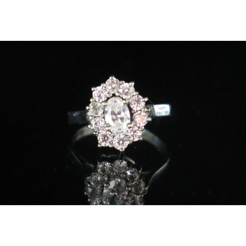 161 - A Diamond Cluster Ring in a precious white metal setting, 13.2x10.9mm head, size K.5, stamped 835, 2... 