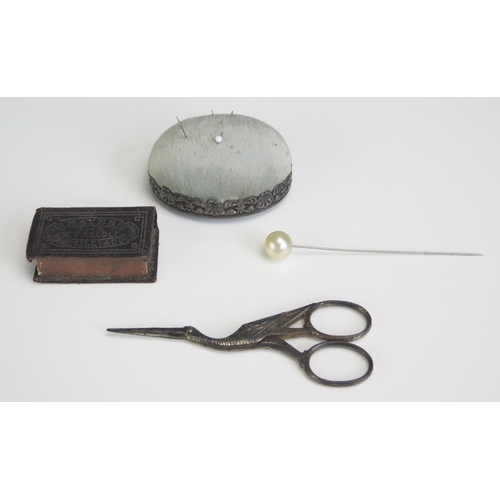 1610 - A sterling silver framed pin cushion, steel scissors in the form of a stalk, etc