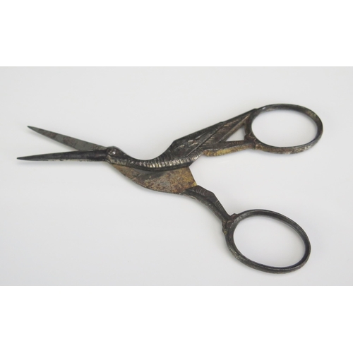 1610 - A sterling silver framed pin cushion, steel scissors in the form of a stalk, etc