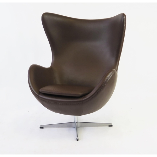 1627 - An Arne Jacobsen style, brown leatherette egg chair on chrome cruciform swivel base.