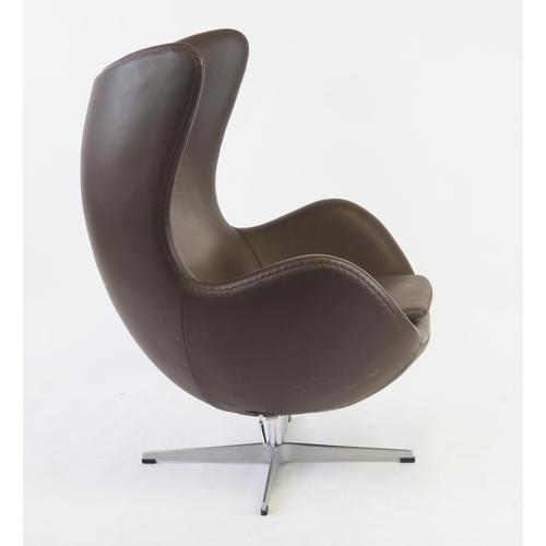 1627 - An Arne Jacobsen style, brown leatherette egg chair on chrome cruciform swivel base.