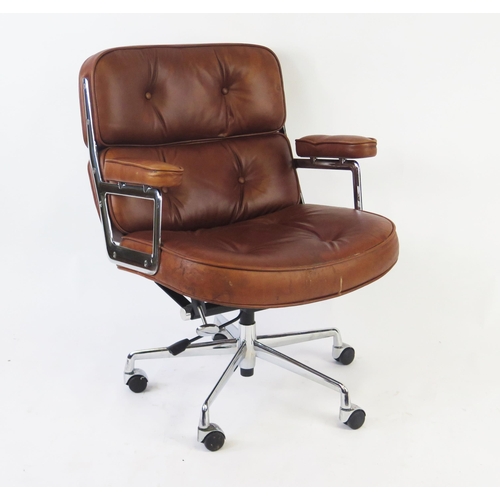 1628 - An Eames style lobby chair, in tan leatherette upholstery.