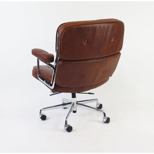 1628 - An Eames style lobby chair, in tan leatherette upholstery.