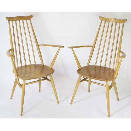 1633 - A pair of Ercol Goldsmith carver chairs, with solid seats on turned under framing. (2).