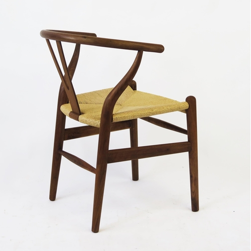 1635 - A Carl Hansen style wishbone chair, with shaped back and armrests, woven cord seat on turned legs.