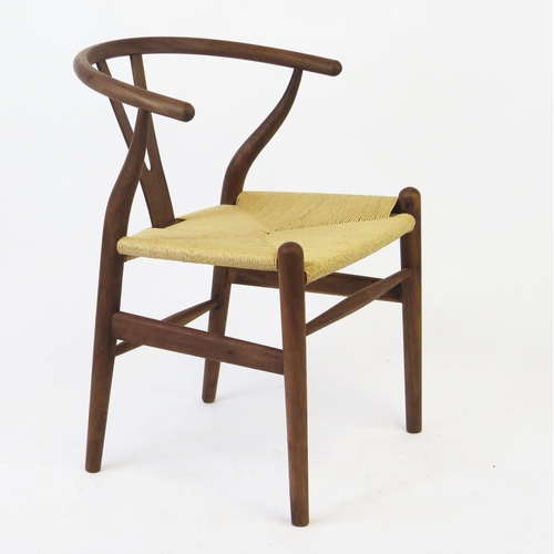 1635 - A Carl Hansen style wishbone chair, with shaped back and armrests, woven cord seat on turned legs.