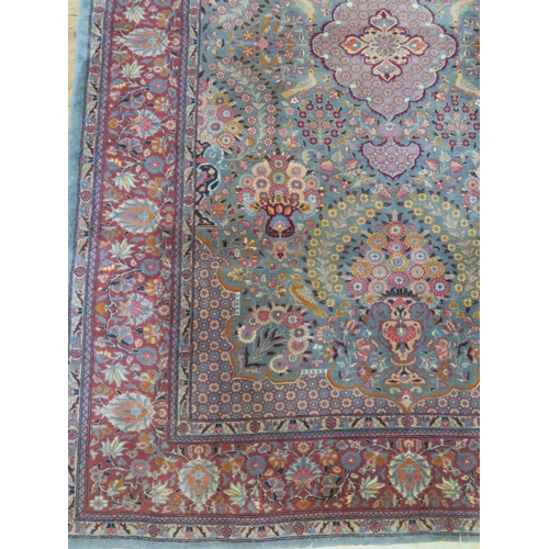 1688 - A Kashan rug, the pale blue field with central pole medallion, and vases of flowers, enclosed by a t... 