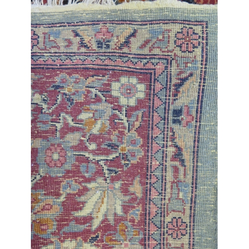 1688 - A Kashan rug, the pale blue field with central pole medallion, and vases of flowers, enclosed by a t... 