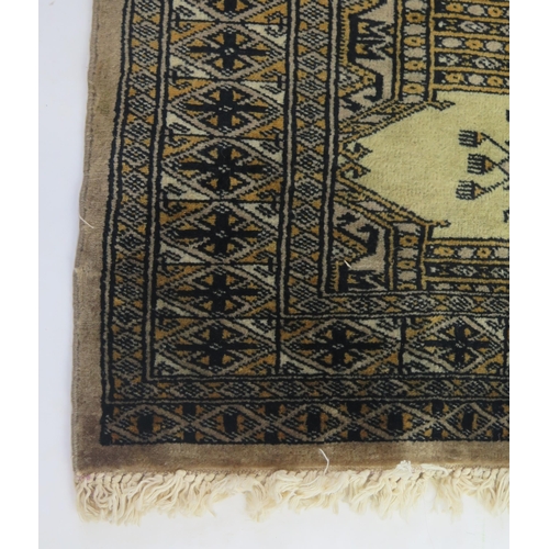 1695 - A Hamadan zaronim rug, the olive green field with two rows of hooked lozenge medallions, enclosed by... 