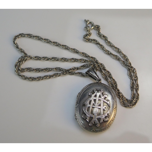 191 - A Victorian Precious White Metal Locket (49mm drop) on a silver chain, 28.45g gross