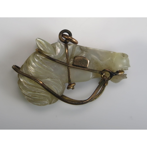 235 - A Mother of Pearl and Gilt Metal Horse's Head Pendant, 34.6mm long