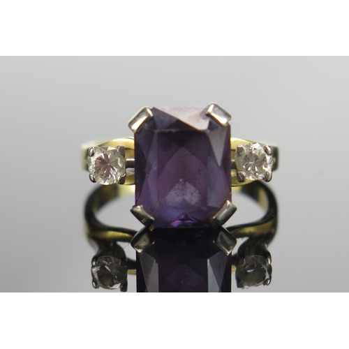 291 - An 18ct Gold, Amethyst and Diamond Three Stone Ring, 10.4x8.3mm principal stone with brilliant round... 