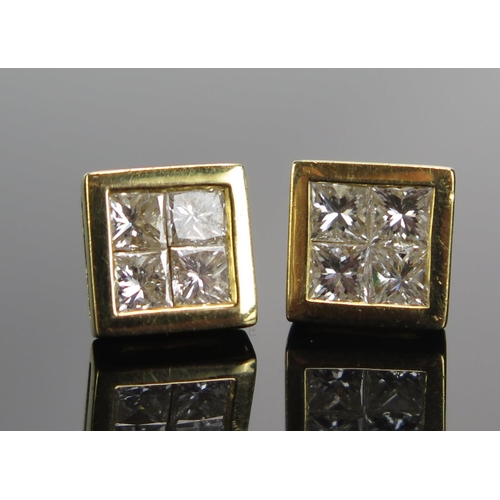 300 - A Pair of 9ct Gold and Invisible Set Diamond Studs, 7.6mm heads, import hallmarks, 2.21g