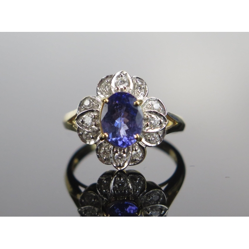 309 - An 18ct Gold, Tanzanite and Diamond Cluster Ring, c. 8.5mm principal stone, 15.35x14/4mm head, size ... 