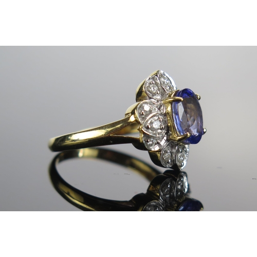 309 - An 18ct Gold, Tanzanite and Diamond Cluster Ring, c. 8.5mm principal stone, 15.35x14/4mm head, size ... 