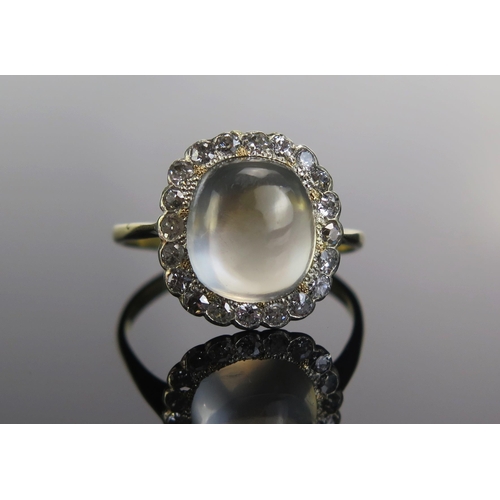 312 - An 18ct Gold, Moonstone and Old Cut Diamond Cluster Ring, 11.6x10mm principal stone, 16.2x15.3mm hea... 