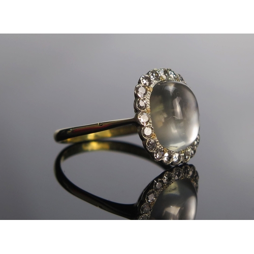 312 - An 18ct Gold, Moonstone and Old Cut Diamond Cluster Ring, 11.6x10mm principal stone, 16.2x15.3mm hea... 