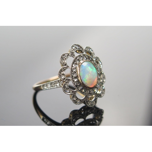 317 - An 18ct Gold, Opal and Old Cut Diamond Ring, 7.2x5.6mm principal stone, 18.25x15.25mm head, size N.5... 