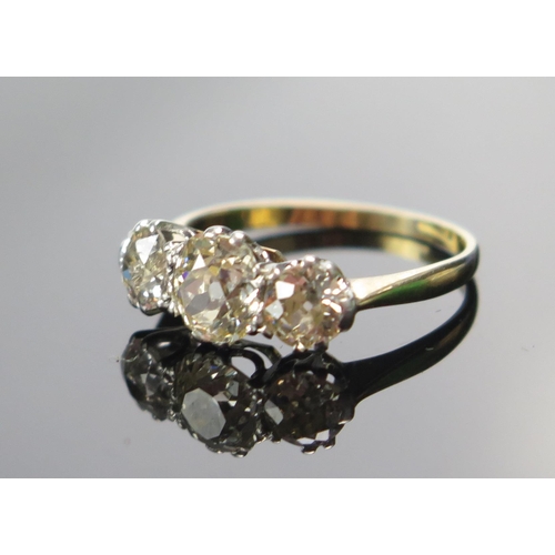 318 - An Old Cut Diamond Three Stone Ring in a high carat precious yellow metal setting, c. 6.2x5.4mm prin... 