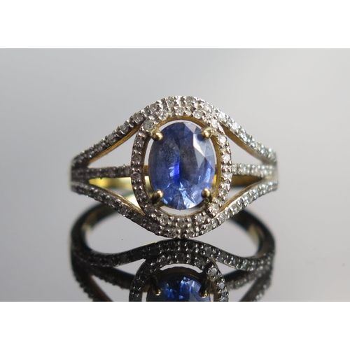 320 - An 18ct Gold, Sapphire and Diamond Cluster Ring, 8.1x6mm principal stone, size N, hallmarked, 4.72g