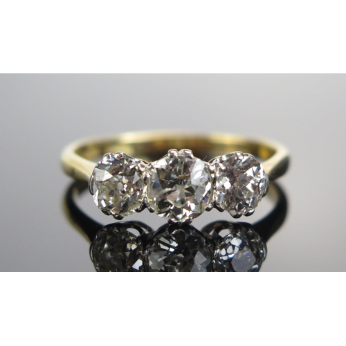 323 - An 18ct Gold and Old Cut Diamond Three Stone Ring, c. 6.05mm principal platinum set stone flanked by... 