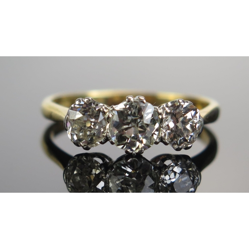 323 - An 18ct Gold and Old Cut Diamond Three Stone Ring, c. 6.05mm principal platinum set stone flanked by... 