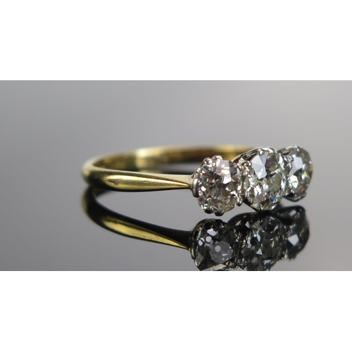 323 - An 18ct Gold and Old Cut Diamond Three Stone Ring, c. 6.05mm principal platinum set stone flanked by... 