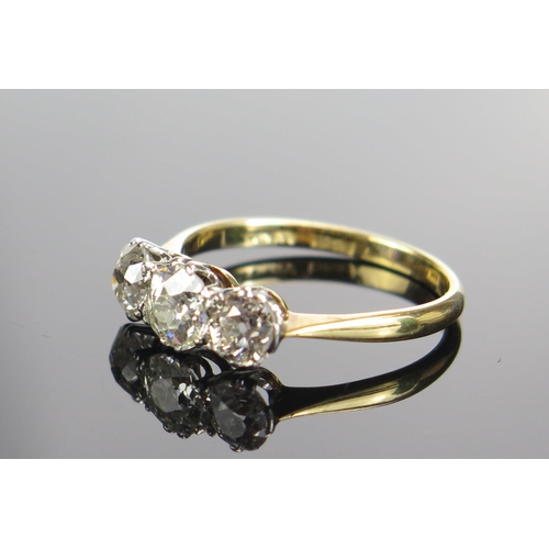 323 - An 18ct Gold and Old Cut Diamond Three Stone Ring, c. 6.05mm principal platinum set stone flanked by... 