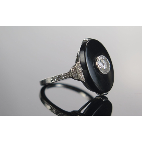 329 - A Modern Onyx and Diamond Ring in a precious white metal setting, c. 4.85mm principal brilliant roun... 