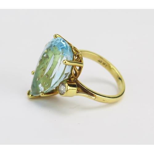 33 - An 18ct Gold Blue Topaz and Diamond Ring, c. 19.1x12.1mm principal pear cut with 2.4mm brilliant rou... 