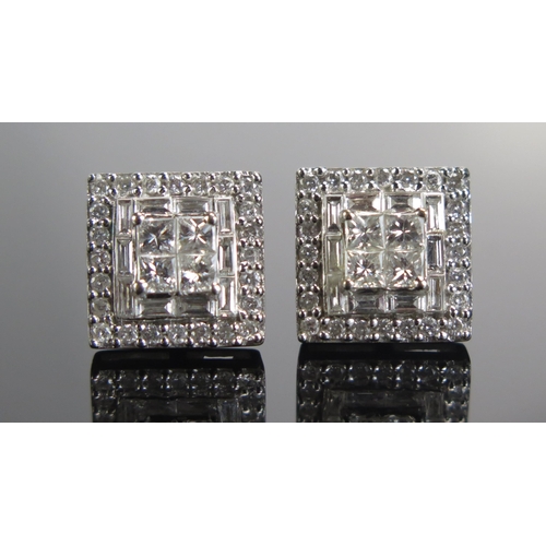 331 - A Pair of Diamond Stud Earrings in a precious white metal setting with princess, baguette and brilli... 