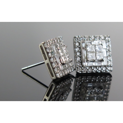 331 - A Pair of Diamond Stud Earrings in a precious white metal setting with princess, baguette and brilli... 