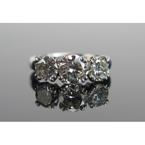 339 - A TIFFANY & CO. Platinum and Diamond Three Stone Ring, 6.9mm principal stone with 5.9mm shoulders, f...