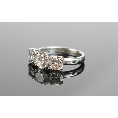 339 - A TIFFANY & CO. Platinum and Diamond Three Stone Ring, 6.9mm principal stone with 5.9mm shoulders, f... 