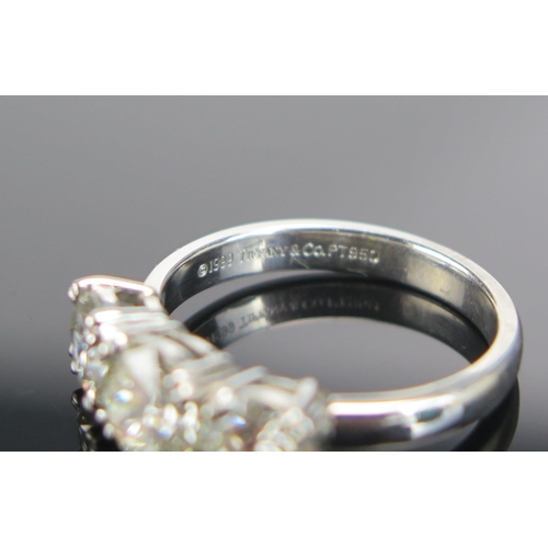 339 - A TIFFANY & CO. Platinum and Diamond Three Stone Ring, 6.9mm principal stone with 5.9mm shoulders, f... 