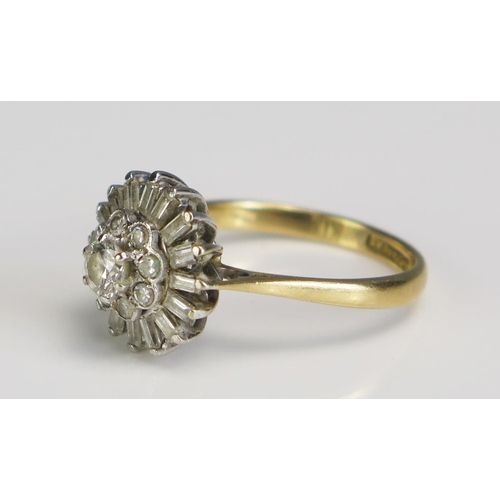 353 - An 18ct Gold and Diamond Cluster Ring, platinum set with brilliant and baguette cuts in a 13mm head,... 