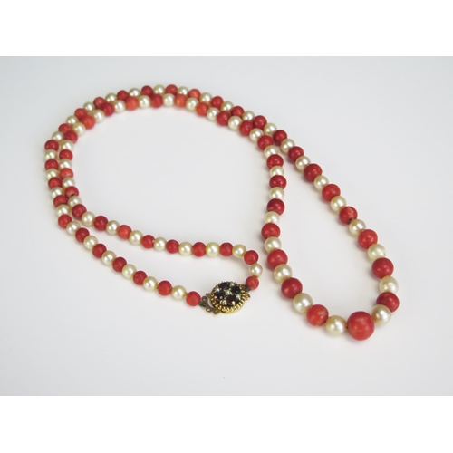 355 - A Coral and Pearl Necklace with a 9ct golf, garnet and pearl clasp, 54.4g