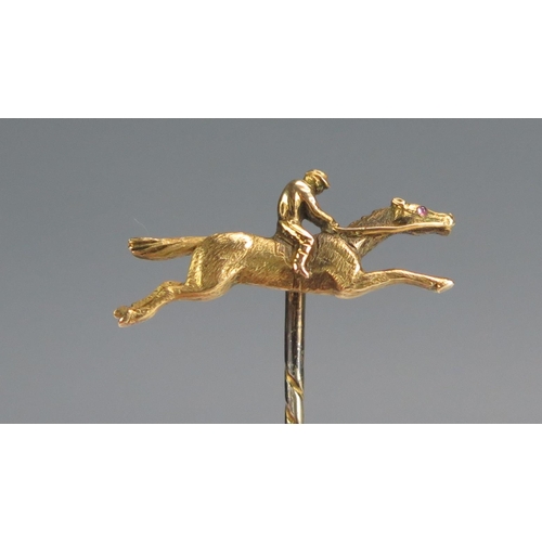 357 - A Precious Yellow Metal Horse and Jockey Pin, KEE tests as 15ct, 3.1g.  UNLESS OTHERWISE STATED, THE... 