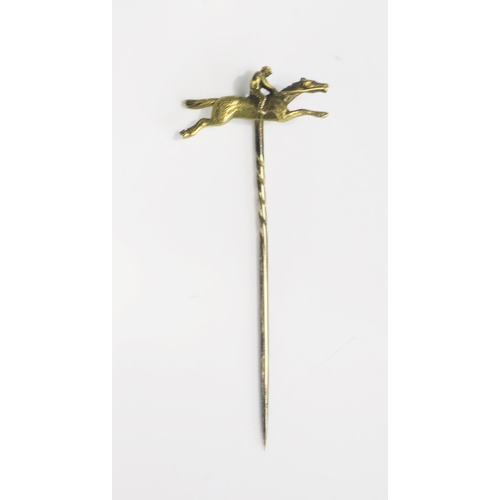 357 - A Precious Yellow Metal Horse and Jockey Pin, KEE tests as 15ct, 3.1g.  UNLESS OTHERWISE STATED, THE... 