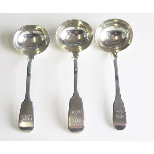 509 - Three assorted silver Fiddle pattern sauce ladles, various makers and dates, crested or initialled, ... 